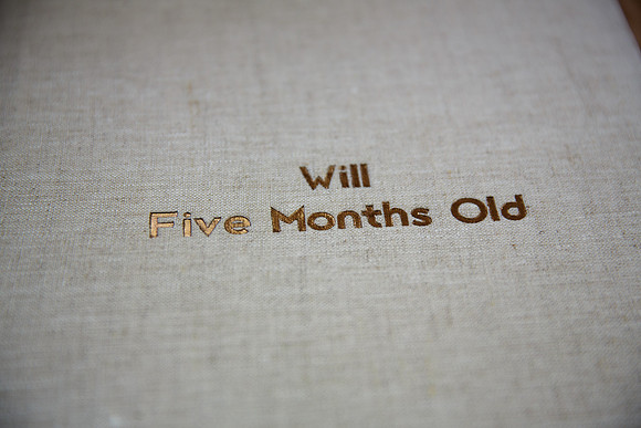 SAND linen Book with DESSAU font in COOPER color debossing